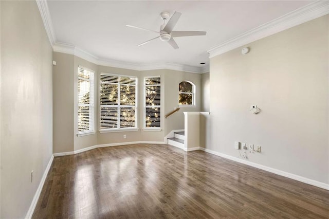 spare room with dark hardwood / wood-style flooring, ceiling fan, and crown molding