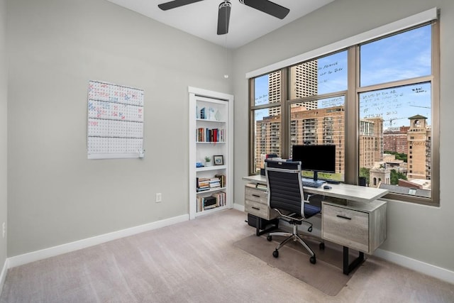 office area featuring ceiling fan, light colored carpet, and baseboards