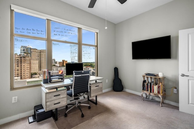 home office with carpet, a ceiling fan, and baseboards