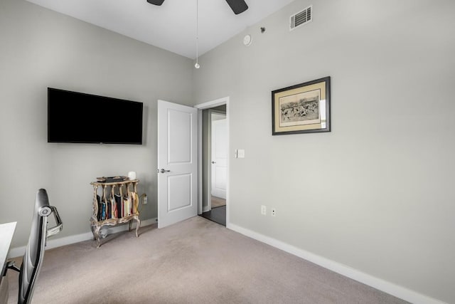 unfurnished bedroom featuring baseboards, ceiling fan, visible vents, and light colored carpet