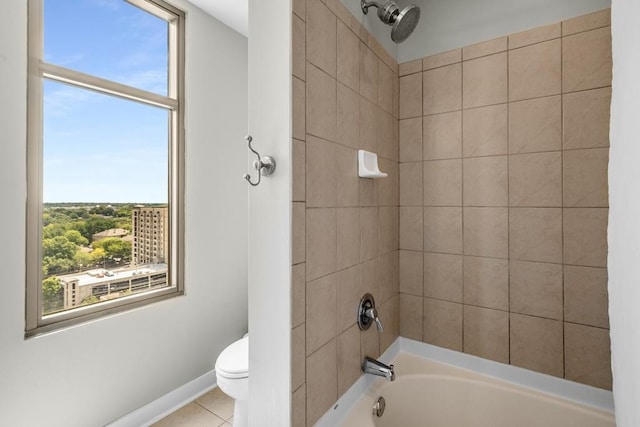 bathroom featuring toilet, baseboards, shower / washtub combination, and tile patterned floors