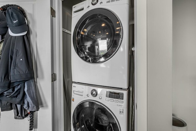 laundry room featuring laundry area and stacked washer / dryer