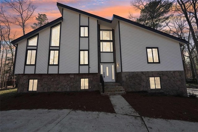 view of front of house featuring stone siding and entry steps