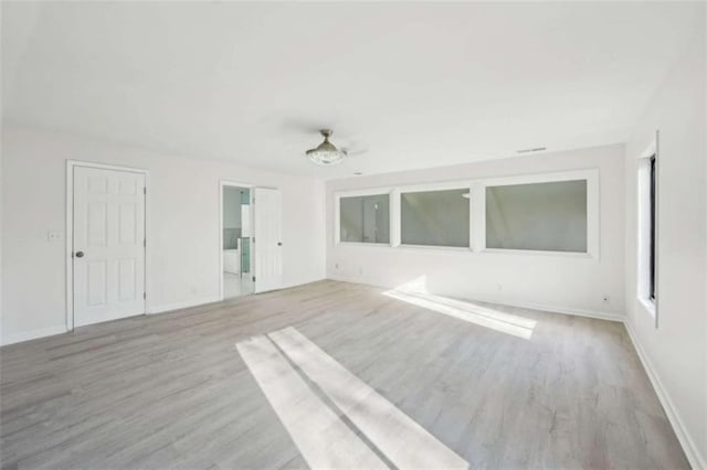 empty room featuring baseboards and wood finished floors