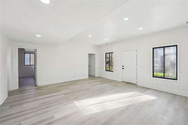 spare room featuring a wainscoted wall, recessed lighting, and light wood-style floors