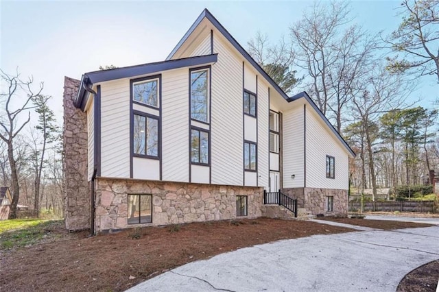 view of side of home featuring stone siding