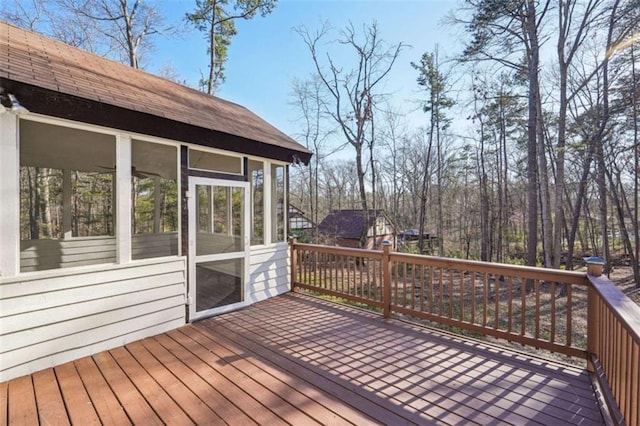 wooden deck featuring a sunroom