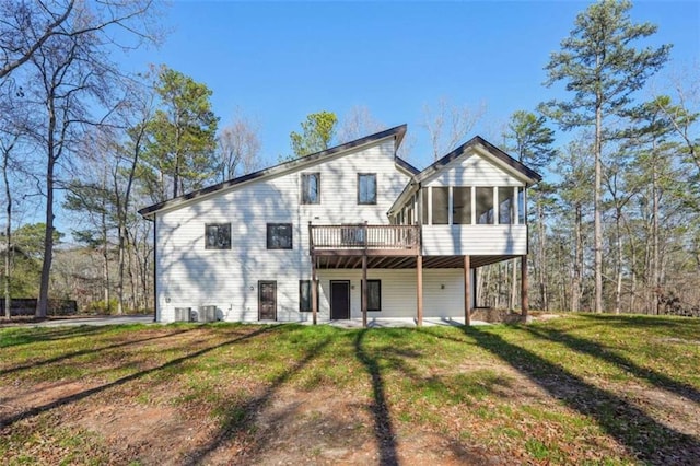 back of house with a yard and a sunroom