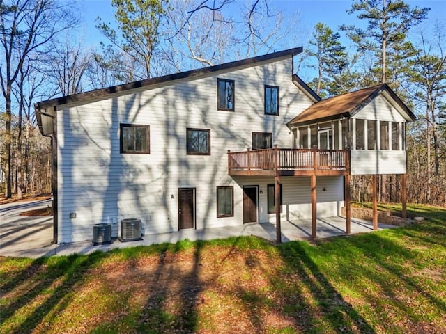 back of property featuring a patio, central AC unit, a yard, a sunroom, and a deck