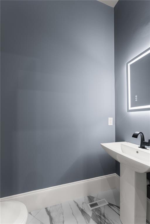 bathroom featuring tile patterned flooring and vanity