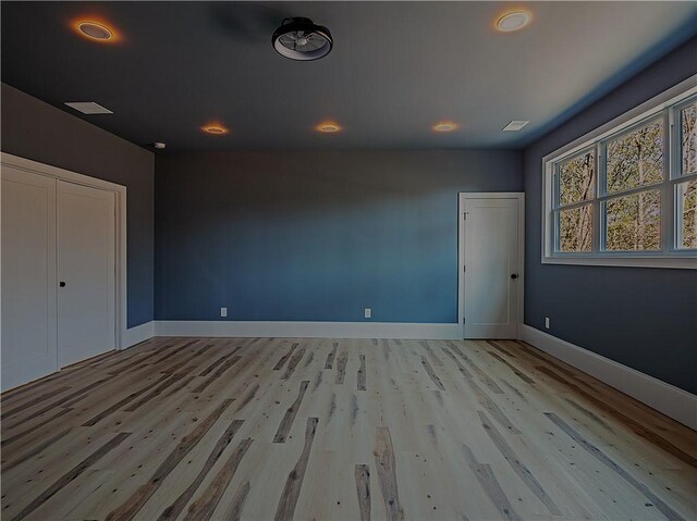 spare room with light hardwood / wood-style flooring