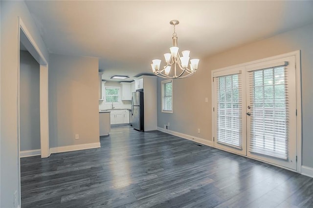 2682 Cavalier Dr, Decatur, GA 30034 - unfurnished dining area featuring dark wood-style flooring, baseboards, and a notable chandelier