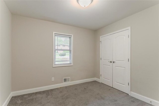 2682 Cavalier Dr, Decatur, GA 30034 - unfurnished bedroom featuring a closet, carpet flooring, visible vents, and baseboards