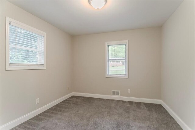 2682 Cavalier Dr, Decatur, GA 30034 - unfurnished room featuring dark colored carpet, visible vents, and baseboards