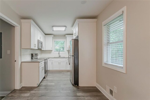 2682 Cavalier Dr, Decatur, GA 30034 - kitchen featuring white cabinets, visible vents, backsplash, and appliances with stainless steel finishes