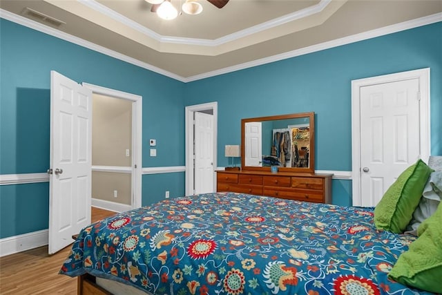 4594 Poplar Rd, Pine Lake, GA 30072 - bedroom featuring wood finished floors, ornamental molding, a ceiling fan, and a tray ceiling