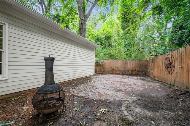 4594 Poplar Rd, Pine Lake, GA 30072 - fenced backyard featuring a patio and an outdoor fire pit