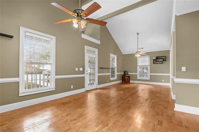 4594 Poplar Rd, Pine Lake, GA 30072 - unfurnished living room with ceiling fan, healthy amount of natural light, beamed ceiling, wood finished floors, and high vaulted ceiling