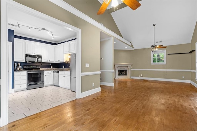 4594 Poplar Rd, Pine Lake, GA 30072 - kitchen featuring appliances with stainless steel finishes, a ceiling fan, white cabinets, open floor plan, and vaulted ceiling