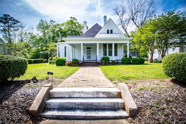 view of front of house with covered porch and a front lawn