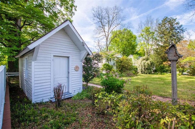 view of outbuilding featuring a yard