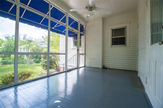 unfurnished sunroom with a wealth of natural light and ceiling fan