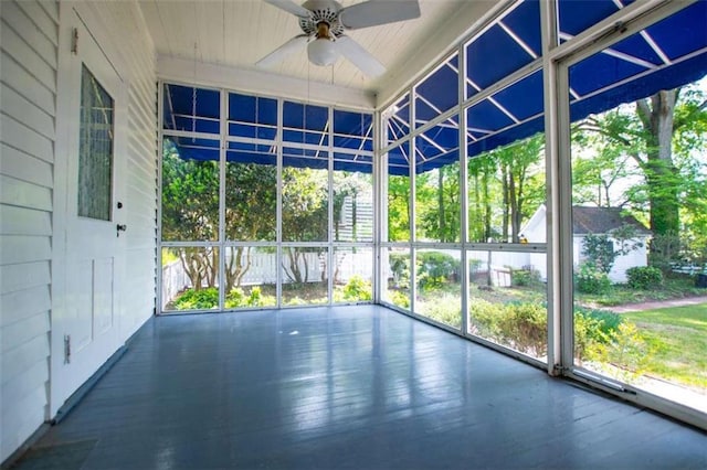 unfurnished sunroom with ceiling fan