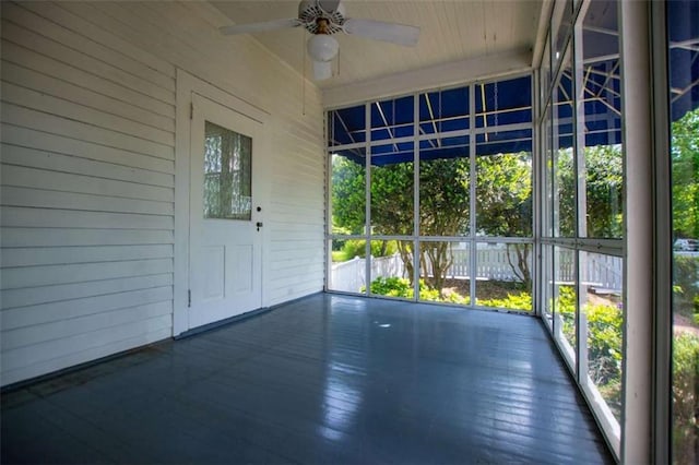 unfurnished sunroom featuring ceiling fan