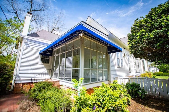 view of side of home featuring a sunroom