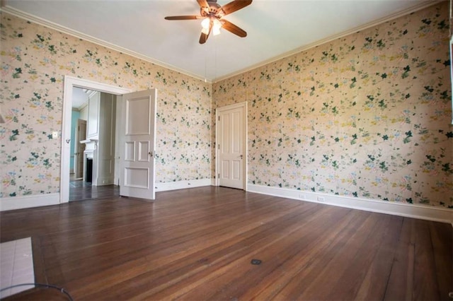 empty room featuring ceiling fan, ornamental molding, and dark hardwood / wood-style flooring