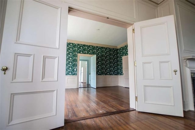 interior space featuring lofted ceiling, crown molding, and dark hardwood / wood-style floors