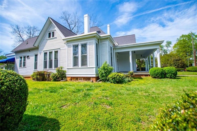 back of house with a yard and covered porch