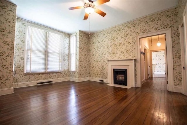 unfurnished living room with dark hardwood / wood-style flooring and ceiling fan