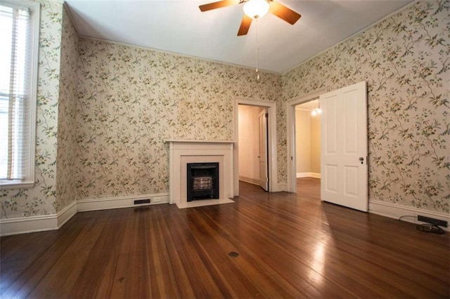 unfurnished living room featuring dark hardwood / wood-style floors and ceiling fan