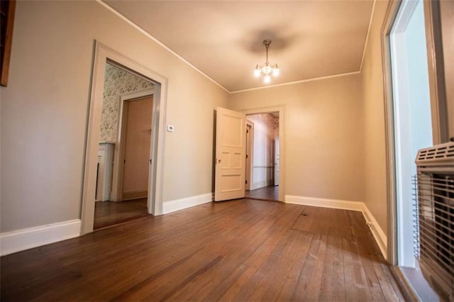 interior space featuring crown molding, dark hardwood / wood-style flooring, and a notable chandelier