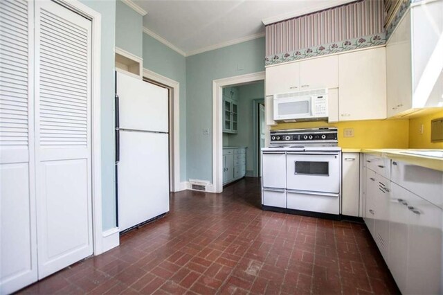 kitchen with crown molding, white appliances, and white cabinets