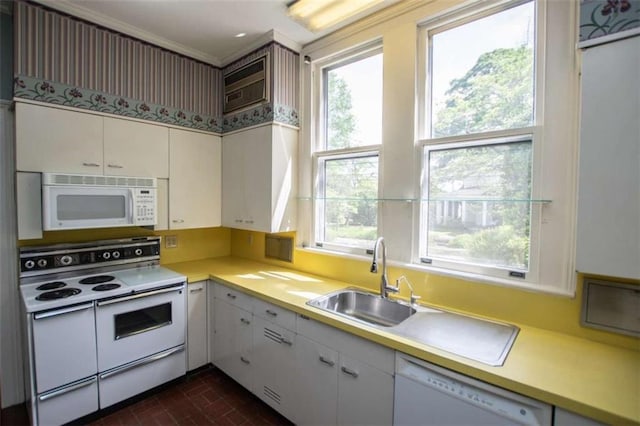 kitchen featuring white cabinetry, sink, and white appliances