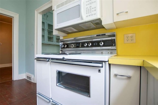 kitchen with white appliances and white cabinets