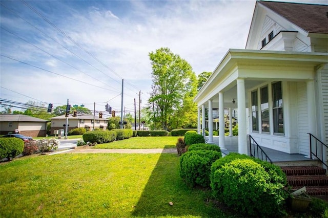 view of yard with covered porch