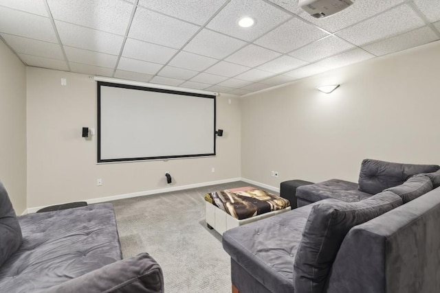 home theater with carpet floors, baseboards, and a drop ceiling