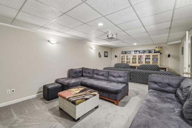 carpeted living area featuring baseboards, a paneled ceiling, and recessed lighting