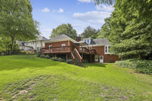 rear view of house featuring a deck, stairs, and brick siding