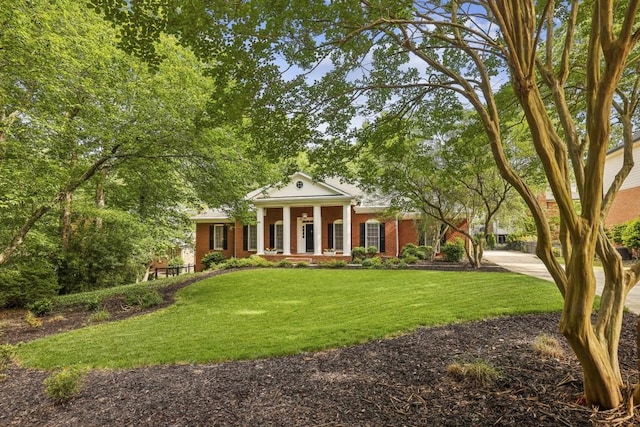 greek revival house with a front lawn and brick siding