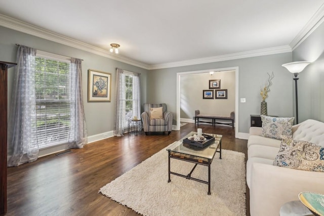 living area with ornamental molding, wood finished floors, and baseboards