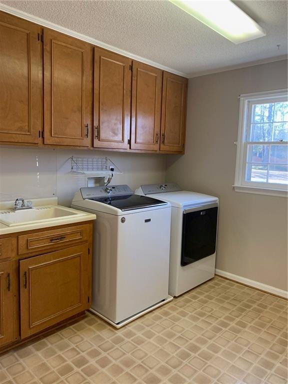 240 W Huntington Rd, Bogart, GA 30622 - laundry area featuring washing machine and clothes dryer, cabinet space, a textured ceiling, light flooring, and baseboards