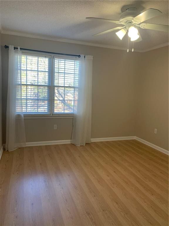 240 W Huntington Rd, Bogart, GA 30622 - unfurnished room featuring light wood finished floors, baseboards, a ceiling fan, crown molding, and a textured ceiling