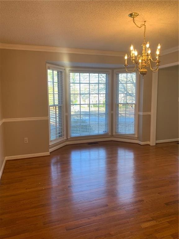 240 W Huntington Rd, Bogart, GA 30622 - empty room featuring a textured ceiling, a chandelier, wood finished floors, baseboards, and crown molding