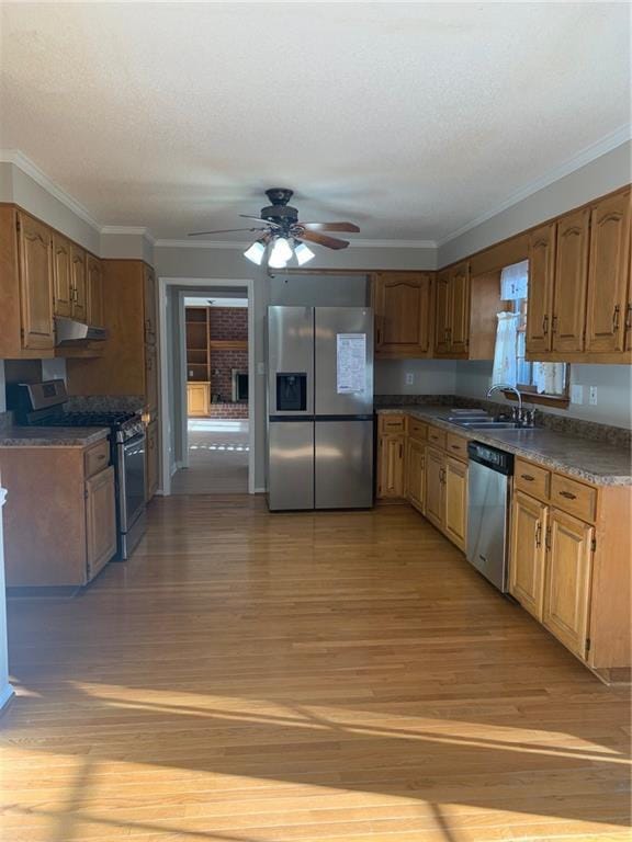 240 W Huntington Rd, Bogart, GA 30622 - kitchen featuring appliances with stainless steel finishes, a sink, ceiling fan, light wood finished floors, and crown molding