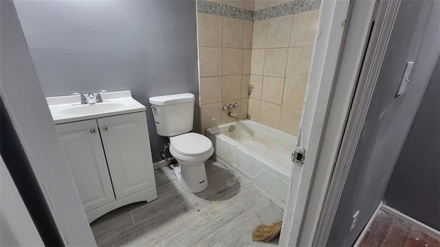 full bathroom featuring vanity, toilet, tiled shower / bath combo, and wood-type flooring