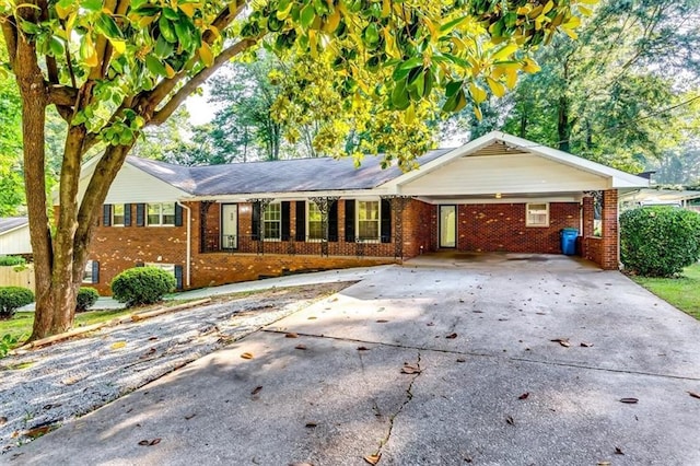 516 Jordan Dr NW, Tucker, GA 30084 - ranch-style home featuring brick siding, driveway, and an attached carport